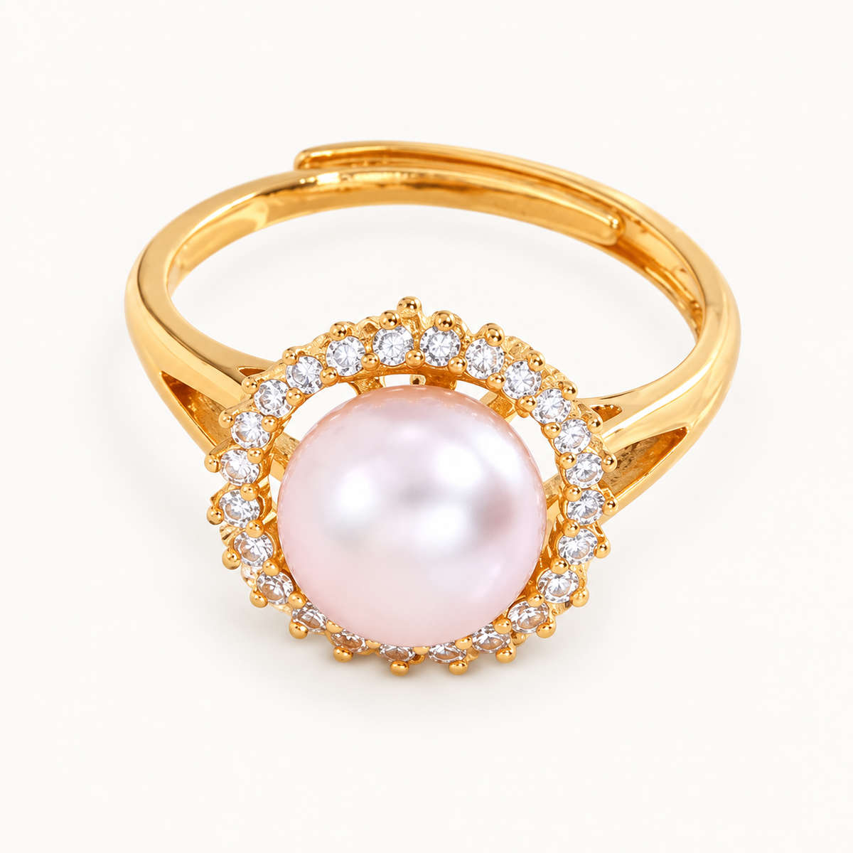 A gold-tone ring with a pale pink pearl-like centre surrounded by clear stones — studio view | Jeweliano