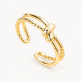 An open gold-tone ring with a central knot and contrasting smooth and beaded lines — studio view | Jeweliano