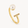 An open gold-tone ring with a pearl-like accent and a short row of clear stones — studio view | Jeweliano