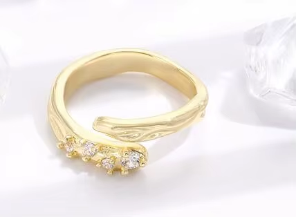 An open gold-tone ring pairing a textured band with a cluster of clear stones — alternate view | Jeweliano