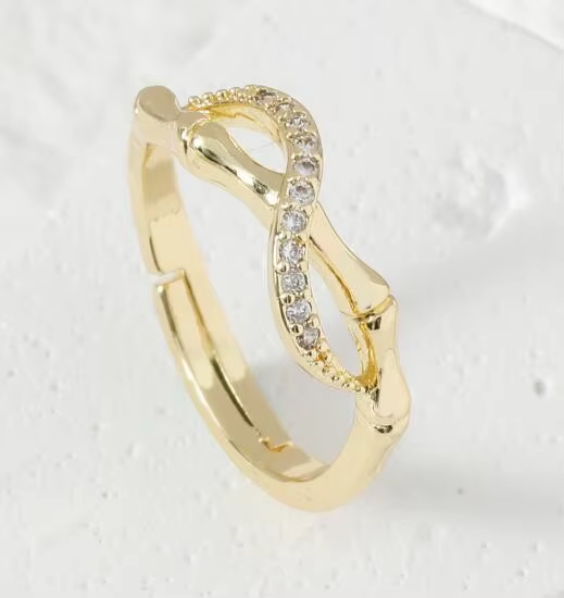 A gold-tone ring with an infinity-inspired silhouette and a line of clear stones — alternate view | Jeweliano