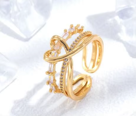 An open gold-tone ring with intersecting lines and clear stone details — alternate view | Jeweliano