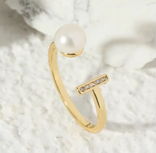 An open gold-tone ring with a pearl-like accent and a short row of clear stones — alternate view | Jeweliano